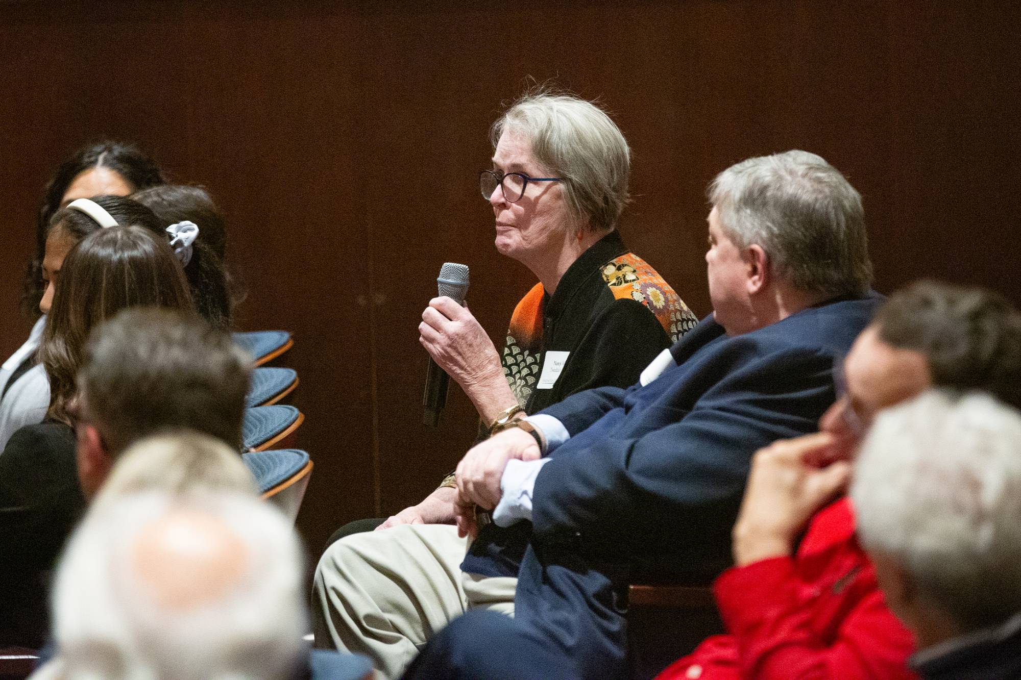two people sitting on stage